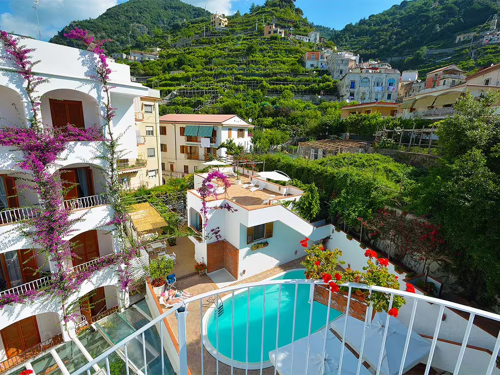 Romantic Amalfi Coast hotel with pool, sea-view terraces and lush hillside gardens, ideal for couples’ spa retreat