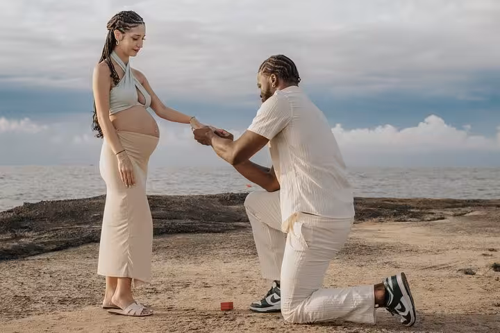 Romantic beachside proposal in Hersonissos with a couple, showcasing a memorable surprise engagement moment.