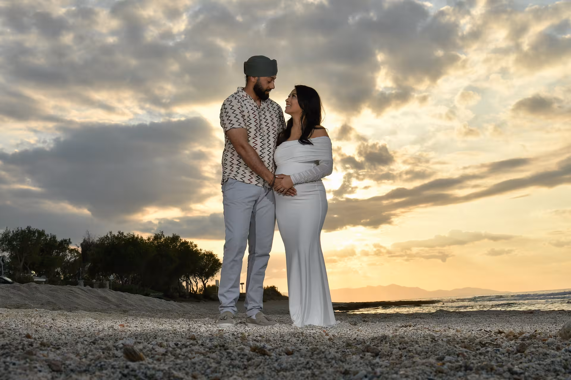 Romantic couple holding hands on Heraklion beach during a private sunset photoshoot, perfect for memorable moments.