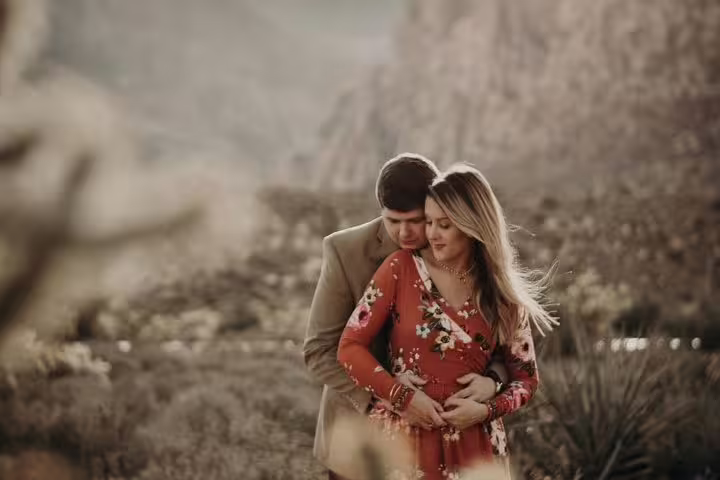 Romantic couple maternity photo in the Las Vegas desert, shot on a personal travel photographer tour