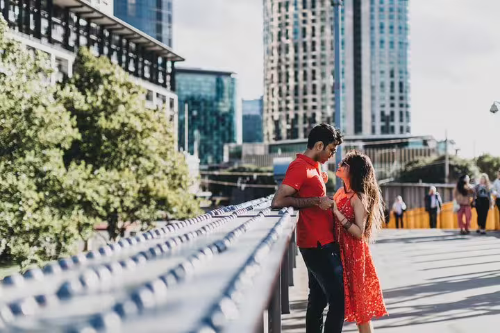 Romantic couple posing on a Melbourne river walkway with skyline, shot on a private travel photographer tour