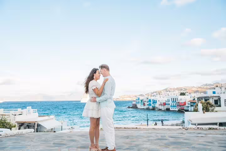 Romantic couple portrait on Mykonos seafront with Little Venice view, private photoshoot with pro photographer
