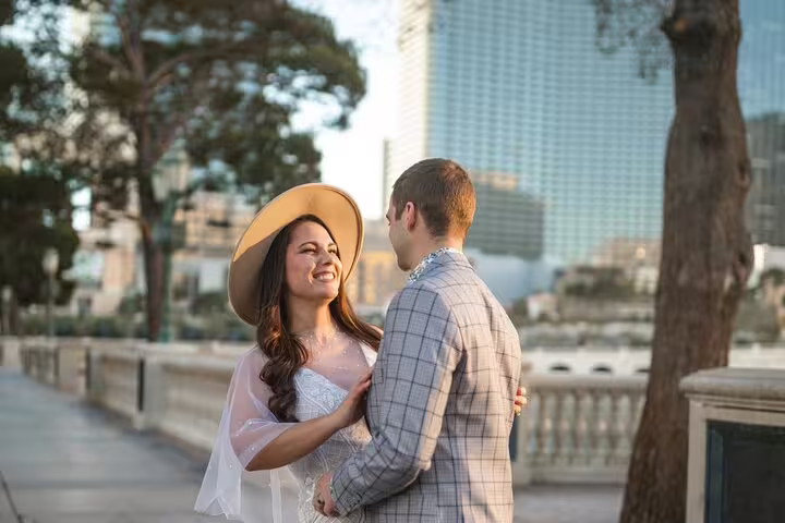 Romantic couple portraits by a Las Vegas personal travel photographer with city skyline at golden hour