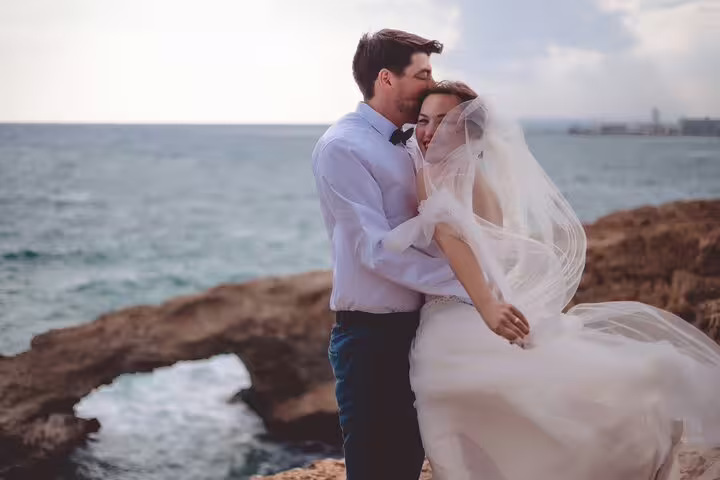 Romantic couple embracing by the sea, captured during a professional photoshoot in Ayia Napa.