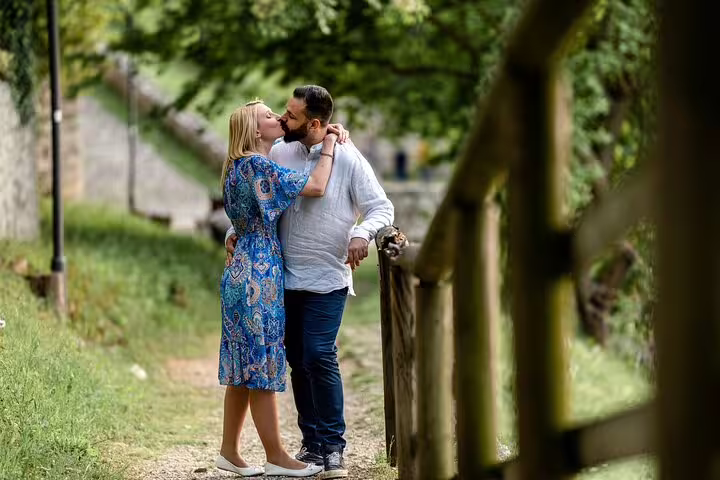 Romantic couple embraces on a scenic Verona path, perfect for capturing love during a professional photoshoot.