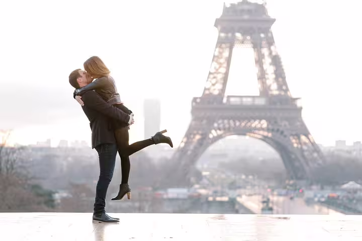 Romantic Paris proposal photo shoot by the Eiffel Tower, couple embracing for engagement pictures
