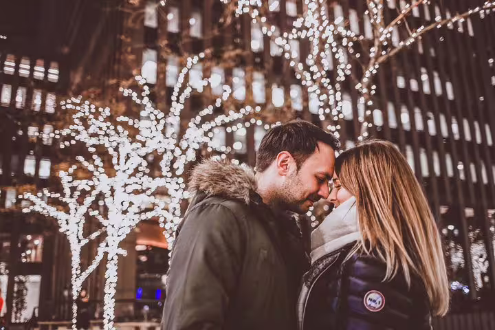 Romantic NYC proposal photo shoot with couple under Midtown holiday lights, captured by New York photographer