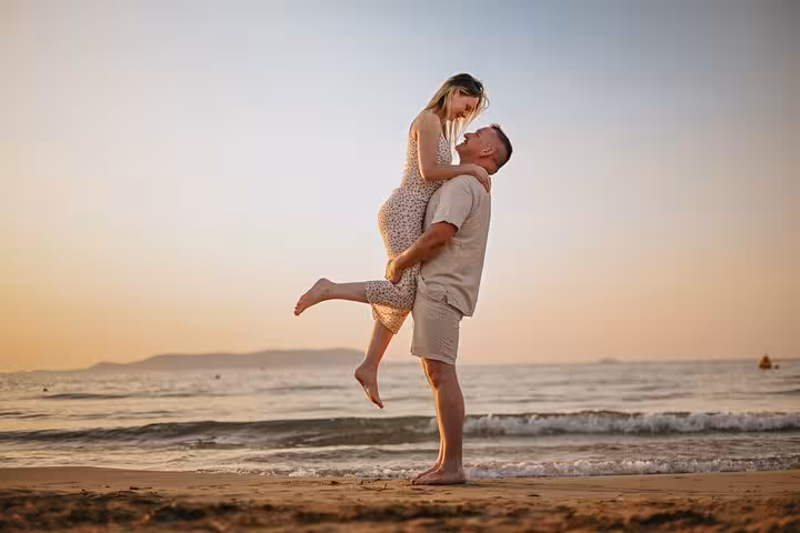 Couple enjoying a romantic sunset photoshoot on Gouves beach, capturing love and scenic ocean views.