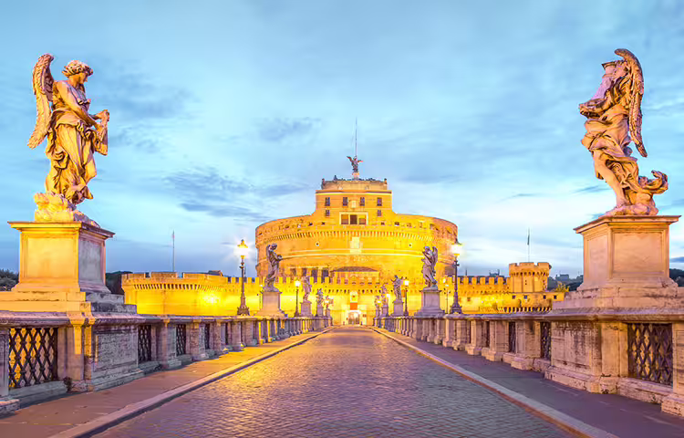 Angel statues on Ponte Sant’Angelo leading to Castel Sant’Angelo at twilight, iconic stop on Rome Angels and Demons tour