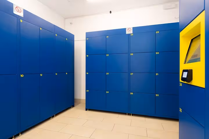 Interior view of Rome Bag Storage featuring numbered blue lockers for secure luggage storage.