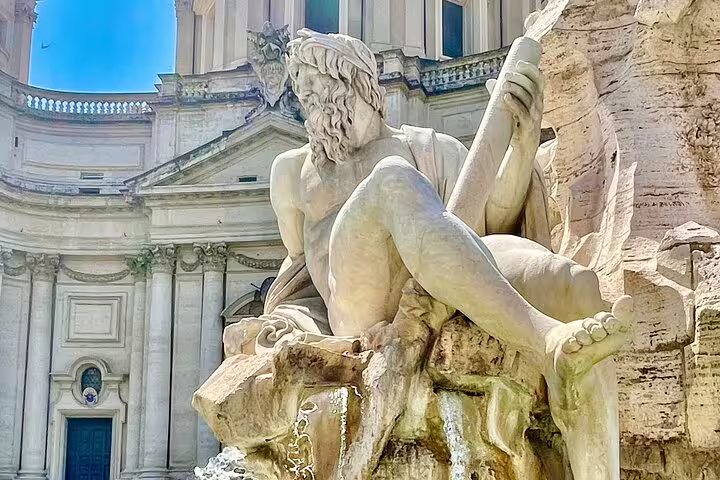 Dramatic Baroque fountain statue in Piazza Navona visited on a Rome Caravaggio and Baroque masterpieces private guided tour