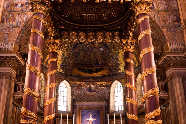 Marvel at the grand, gilded interior of a famous Roman basilica, featuring stunning columns and mosaics.