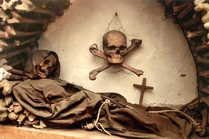 Macabre display of skulls and bones in Rome's Bone Crypts, highlighting the city's mysterious history.