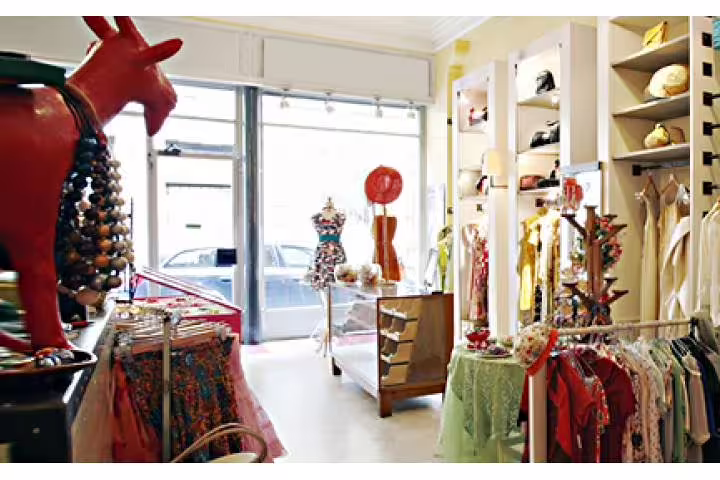 Chic Rome boutique filled with colorful dresses and accessories, ideal stop on an exclusive full day shopping tour with personal shopper