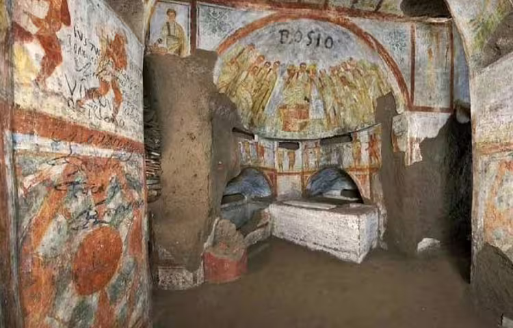 Colorful early Christian frescoes and stone sarcophagi in a chamber of the Rome underground catacombs and crypts
