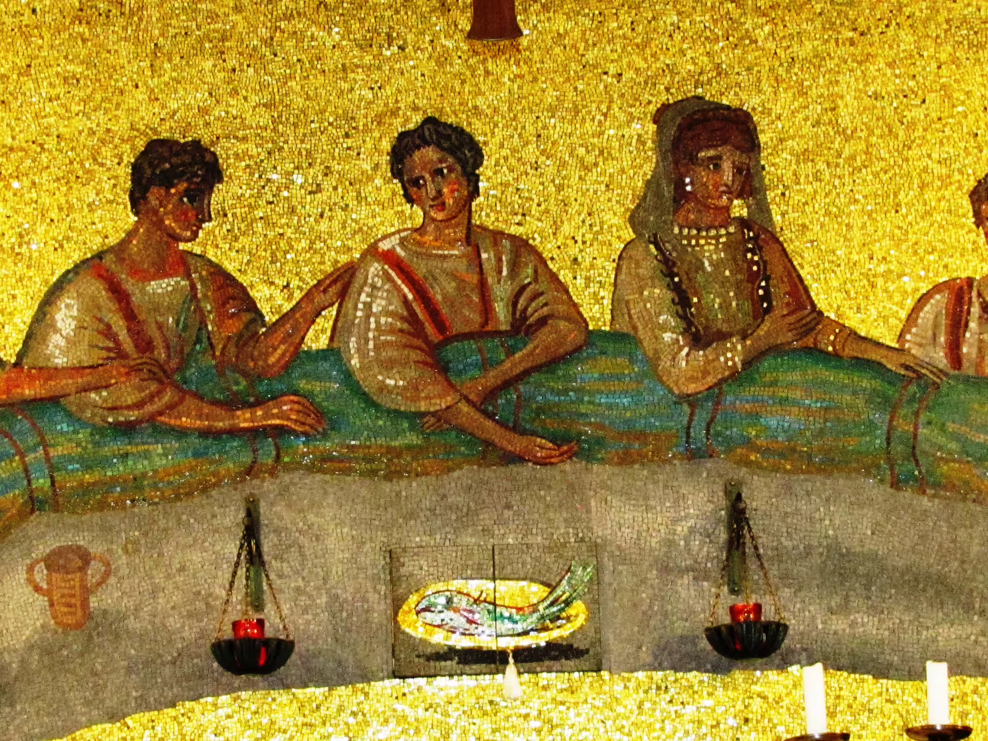Colorful early Christian mosaic of banquet scene inside Rome catacombs, depicting saints above altar in underground crypt chapel