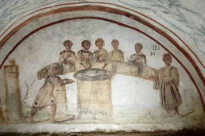 Early Christian fresco of figures around a well in Rome catacombs, seen on Colosseum underground and catacombs tour