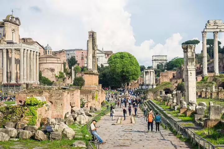 Tourists walking among temples and ruins in the Roman Forum on an in-depth Ancient Rome and Colosseum private tour