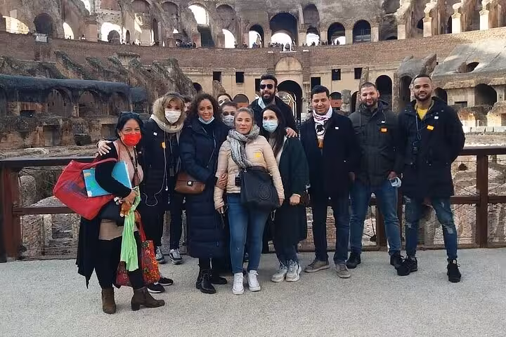 A group of tourists inside the Colosseum arena during the Rome Underground Tour.