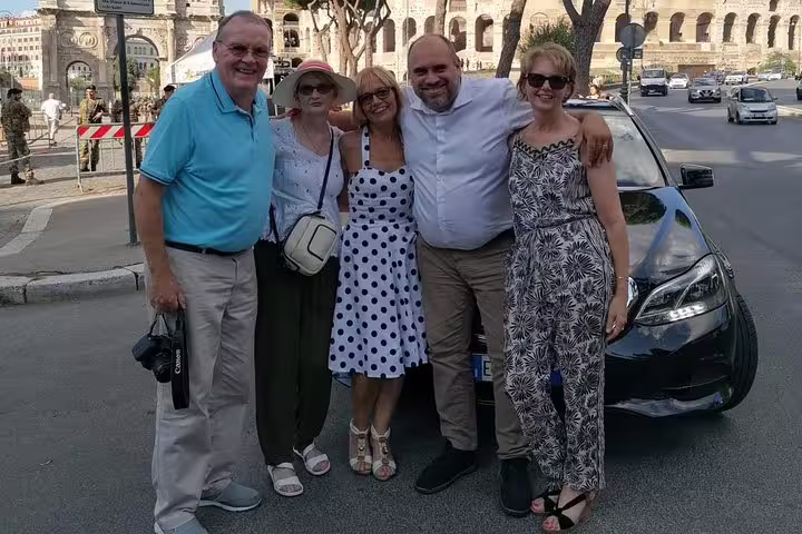 Guests with private driver by the Colosseum on a Rome half-day sightseeing tour with luxury car pickup