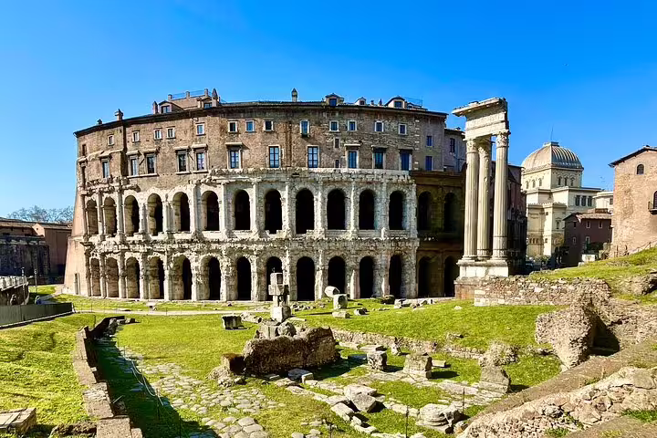Ancient theater ruins and columns near the Roman Forum visited on a Best of Rome Colosseum, squares and fountains tour