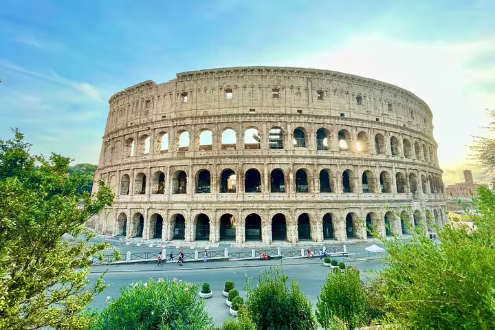 Panoramic view of Rome Colosseum at sunrise on a Best of Rome private walking tour of ancient squares and fountains