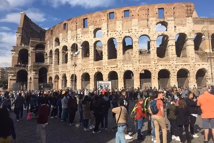 Crowds gather outside the iconic Colosseum for the Rome Underground and Arena Tour.