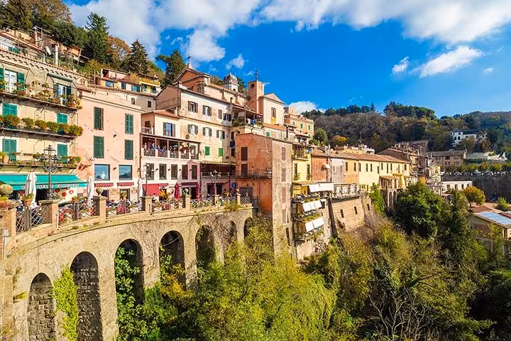 Colorful hillside village in the Roman countryside, offering a scenic view perfect for a Vespa adventure.
