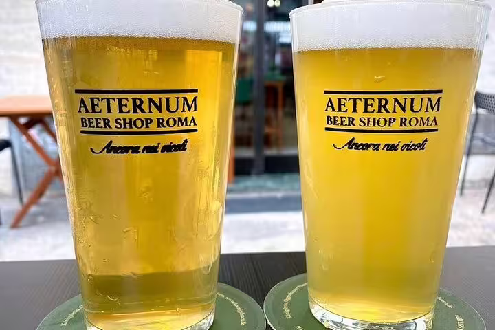 Two frosty glasses of craft beer from Aeternum Beer Shop Roma, perfect for the Vatican's Craft Beer Private Tour experience.