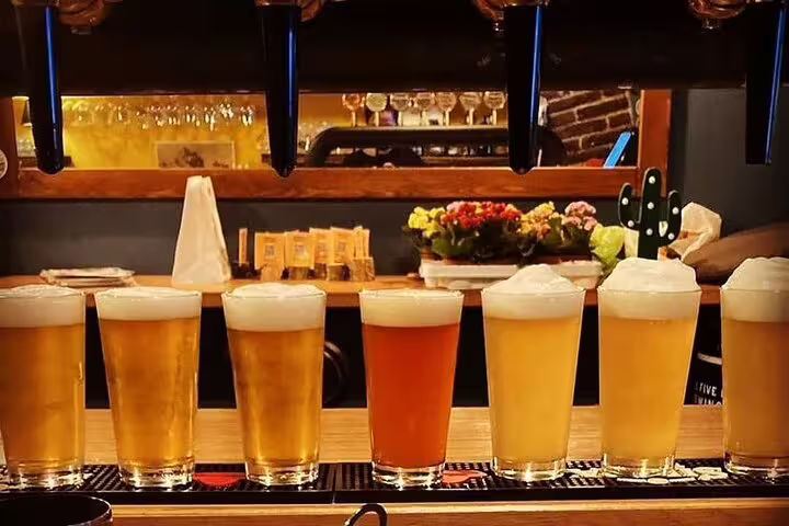 A row of craft beers on tap at a cozy bar, perfect for a Vatican's Craft Beer Private Tour with a local foodie experience.