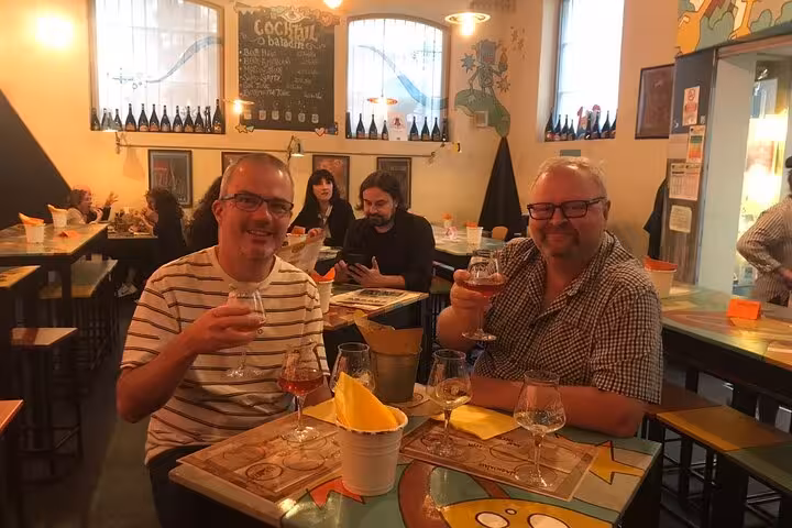 Guests savor craft beers at a lively bar during the Rome Night Craft Beer Walking Tour.