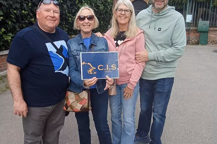 Tourists enjoy a guided tour experience at Rome's Domus Aurea, holding a C.I.S. sign, ready for virtual reality exploration.