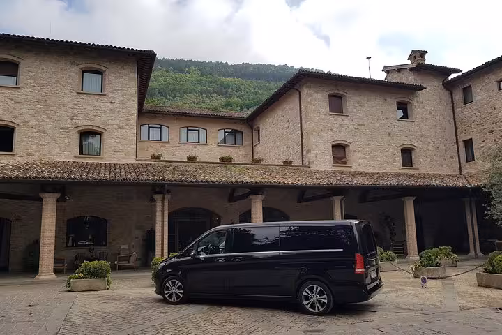 Black chauffeur minivan at hotel pickup in Rome for transfer to Fiumicino Airport, private airport shuttle service