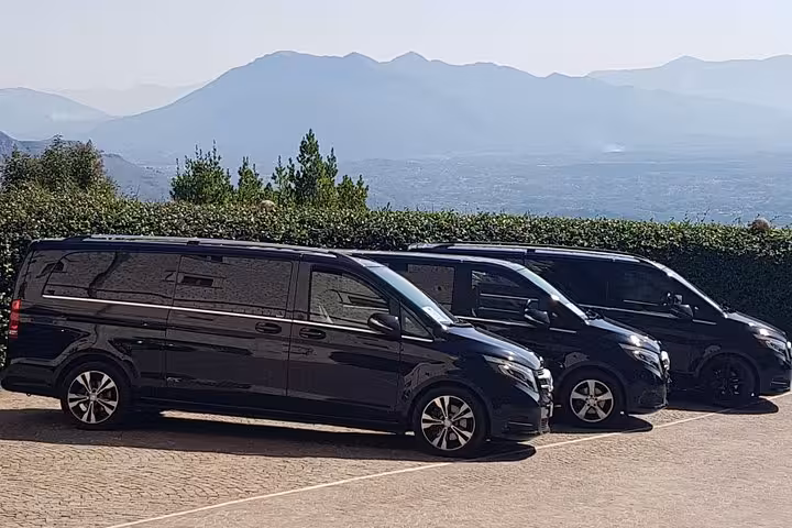 Fleet of black minivans for private transfer from Rome to Fiumicino Airport, reliable door-to-door service