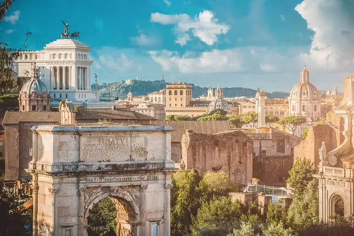 Panoramic view of the Roman Forum and Arch of Titus with Vittoriano monument, seen on a private chauffeured tour of Rome