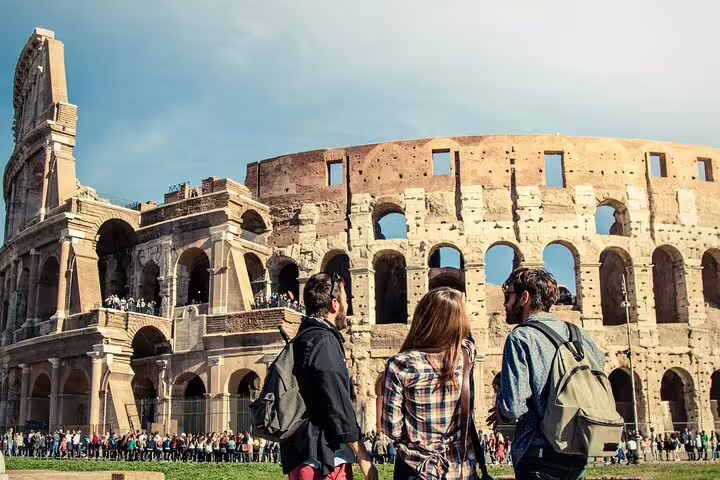 Tourists admire the iconic Colosseum in Rome, part of an immersive tour including the Forum, Pantheon, and Castel Sant'Angelo tickets.