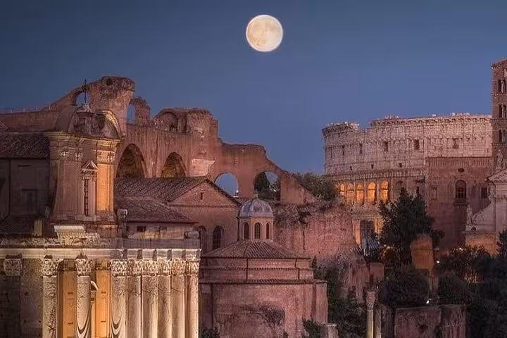 Full moon over the ancient Roman Forum ruins, showcasing historic sites on the golf cart tour in Rome.