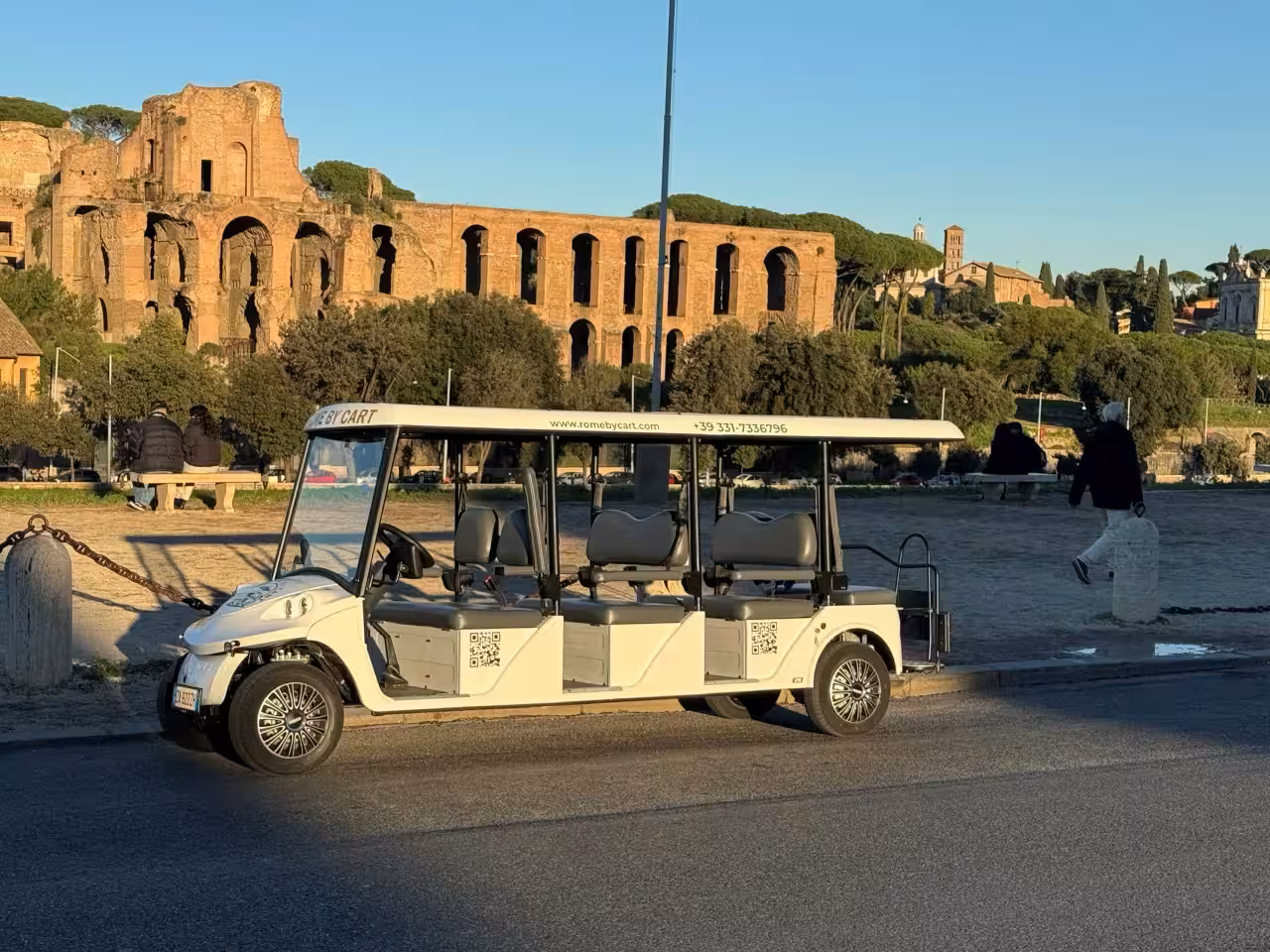 Golf cart tour showcasing Rome's ancient architecture and lush greenery in a unique sightseeing experience.