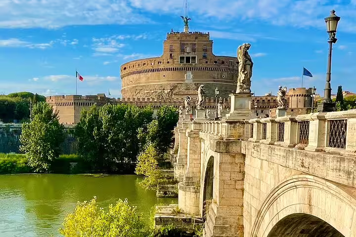 Castel Sant’Angelo and the statues of Ponte Sant’Angelo seen from the Tiber River on a Rome hop on hop off open bus tour route