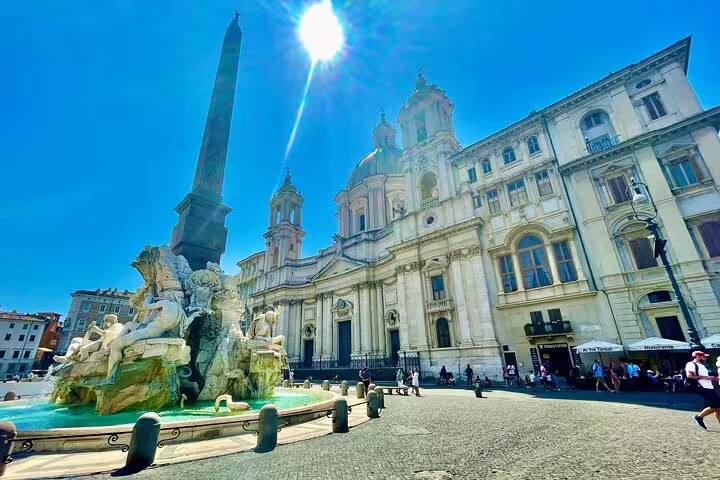 Fountain of the Four Rivers in Piazza Navona on a sunny Rome hop on hop off bus and Vatican Museums Sistine Chapel combo tour