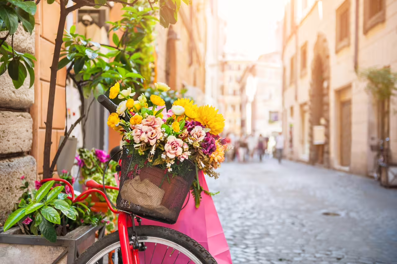 Explore Rome's charming streets adorned with flowers and vibrant bicycles on our Italian food discovery tour.