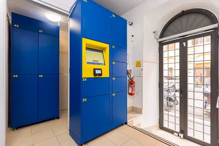 Modern luggage storage facility in Rome with secure blue lockers and digital access for convenient storage.