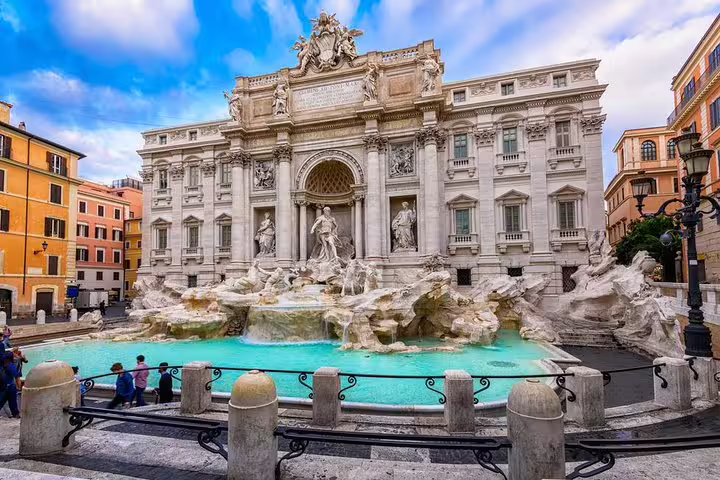 Tourists visiting the Trevi Fountain, a must-see landmark on a Rome in One Day private tour with hotel pick-up