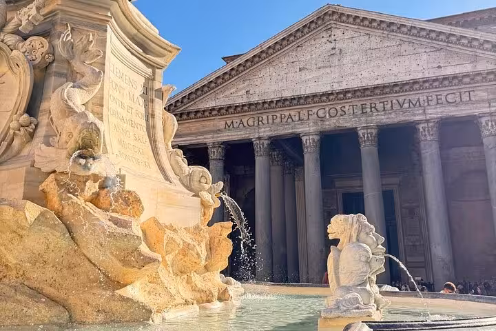 The Pantheon's majestic entrance with a nearby ornate fountain, part of the fast track experience in Rome.