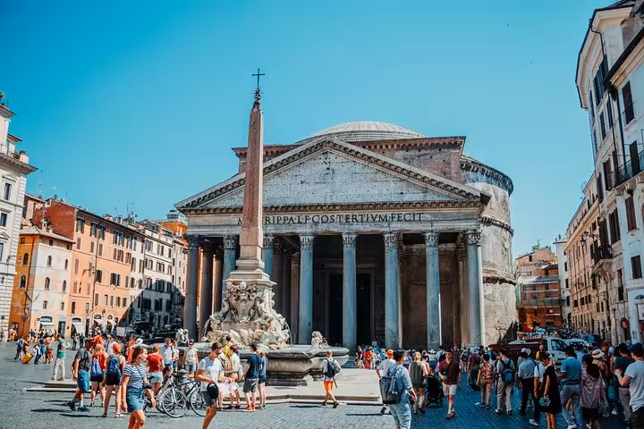 Tourists explore Rome's historic Pantheon and bustling piazza on a guided golf cart tour.
