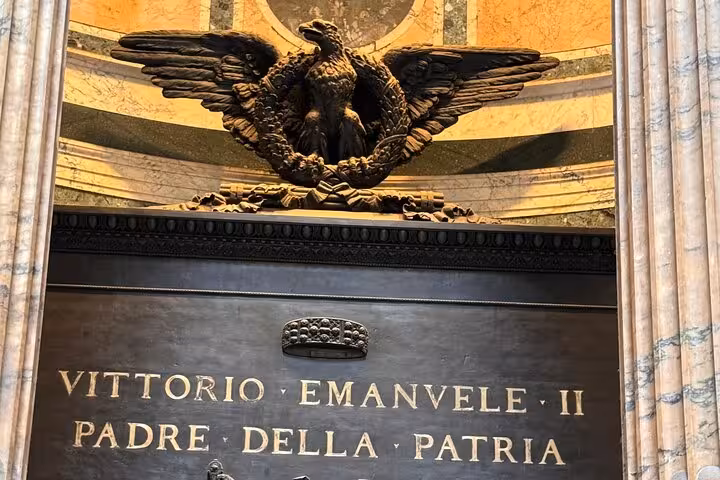 Close-up of a historical inscription and eagle sculpture inside the Pantheon in Rome.