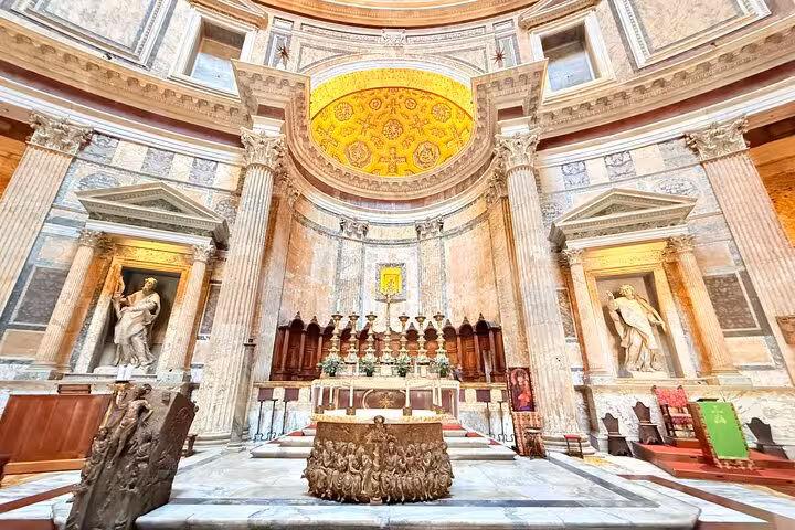 The Pantheon's interior features a stunning altar with detailed sculptures and an ornate golden dome ceiling.