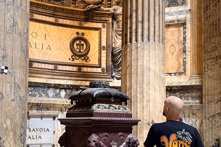 Visitor admires intricate details inside Rome's Pantheon, highlighting its rich history and architectural grandeur.