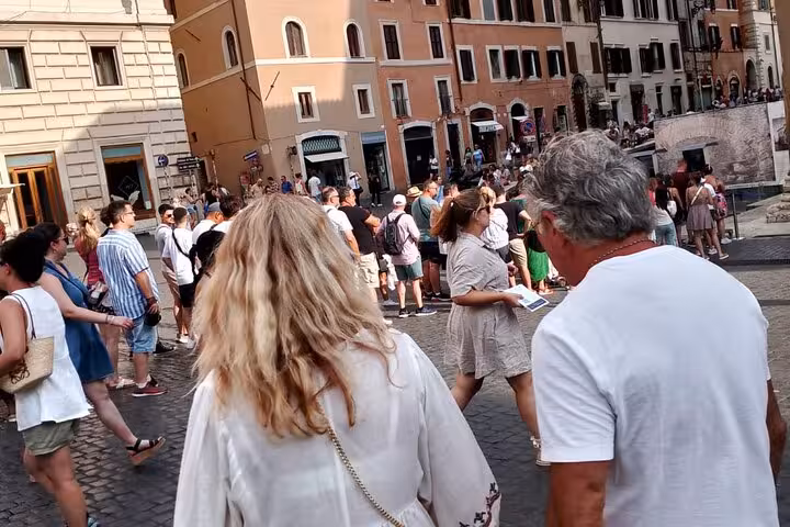 Visitors explore the bustling area near the Pantheon in Rome, preparing to enjoy a guided tour of this historic site.