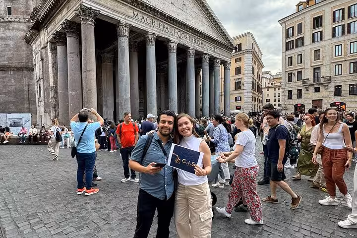 Visitors posing in front of Rome's iconic Pantheon, capturing the lively atmosphere and historic charm.